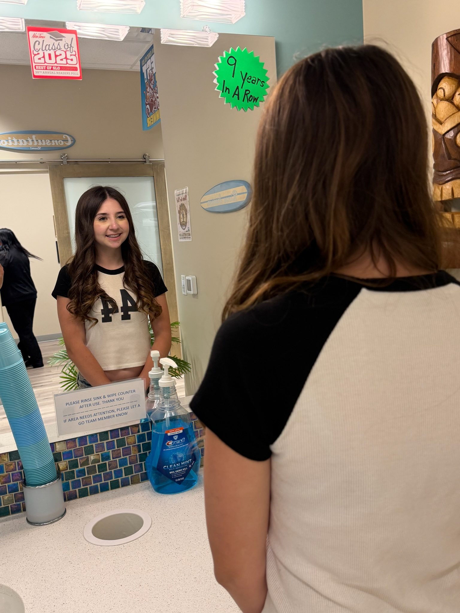 A patient checking her smile in the mirror.
