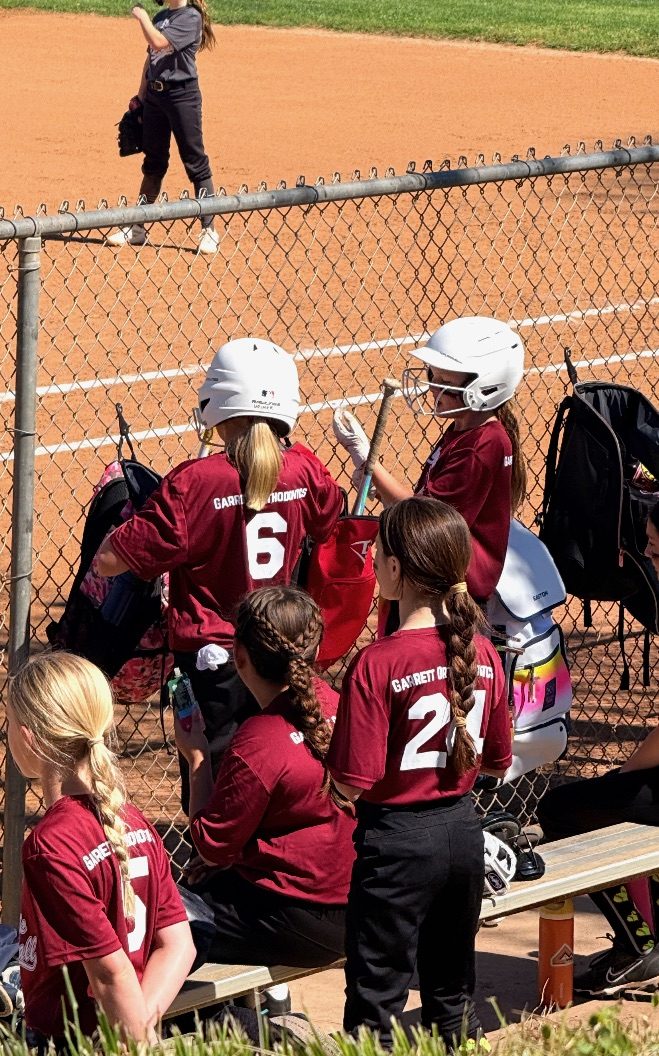 The youth softball team Garrett Orthodontics sponsors, in their team jerseys.